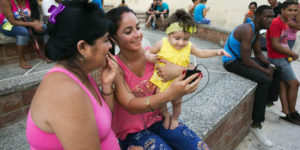 A family in Camag¸ey uses a Wi-Fi hotspot in a public plaza to let a baby girl talk with her father. Saturday June 25, 2016.